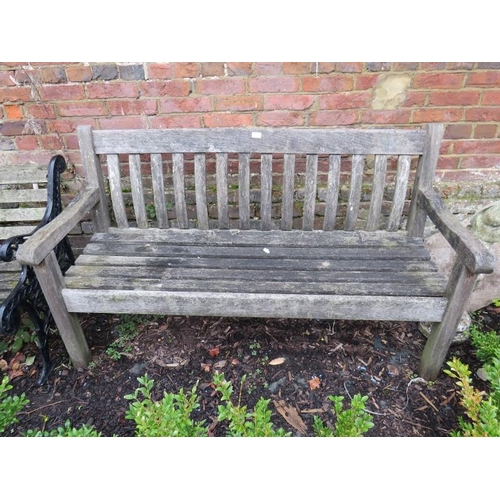 899 - A vintage weathered teak slatted garden bench, on square supports. 
H90cm W154cm D64cm (approx).
Con... 