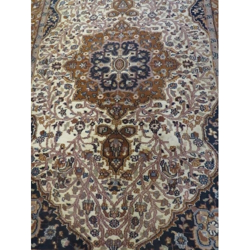 911 - Persian rug Tabriz in browns and beige central motif upon floral panel blue ground corners within bo... 