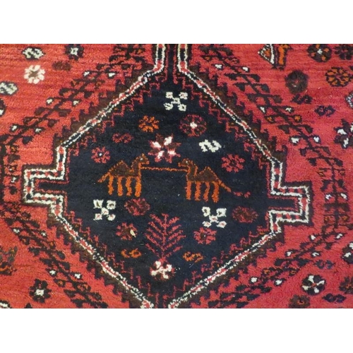 918 - Shiraz rug medallion design, 3 central motifs on red ground, beige border. 252cm x 168cm.
Condition ... 