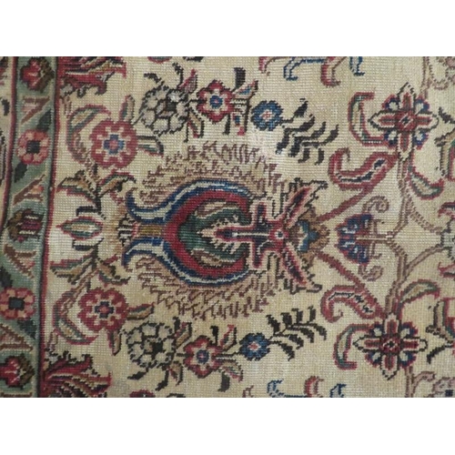 919 - North West Persian Tabriz carpet, floral field upon beige ground, greens and reds to border, edged b... 