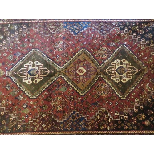 924 - South West Persian Qashqai carpet, 3 central motifs on red ground, floral pattern, edges to sides. 2... 