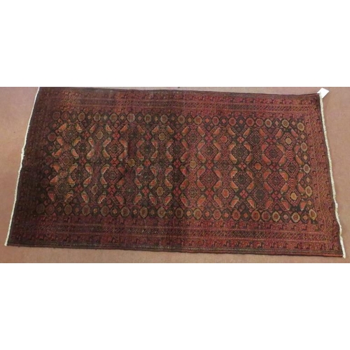 927 - North East Persian meshed Belouch rug, central panels of reds and blues. 183cm x 100cm.
Condition re... 