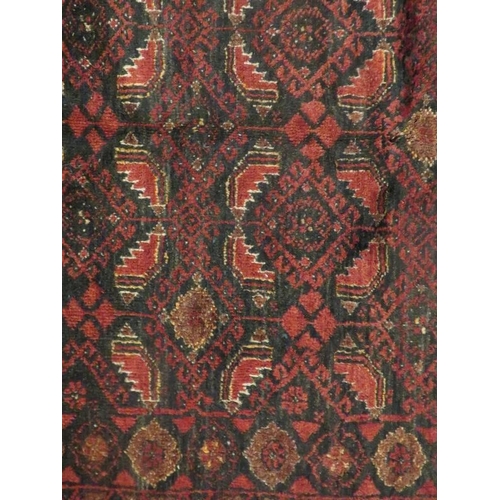 927 - North East Persian meshed Belouch rug, central panels of reds and blues. 183cm x 100cm.
Condition re... 