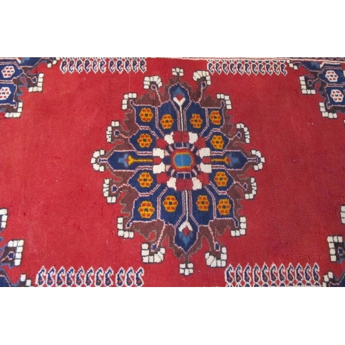 933 - A Persian Tafresh rug (c Persia) with Mifraic sun medallion 1/4 spandrels on open Ferrari red field.... 