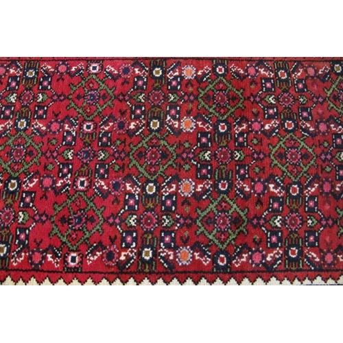 934 - A good Hoseinabad small runner in very good condition. Repeat central pattern on claret field. 190cm... 