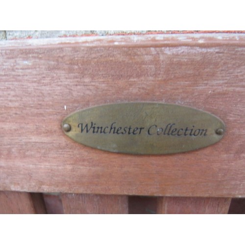 896 - A pair of vintage weathered teak folding steamer chairs with applied plaques 'Winchester Collection'... 