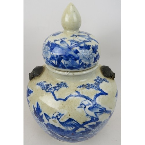 63 - A 19th century Chinese blue and white crackle ware porcelain vase and cover in the Kangxi style pain... 