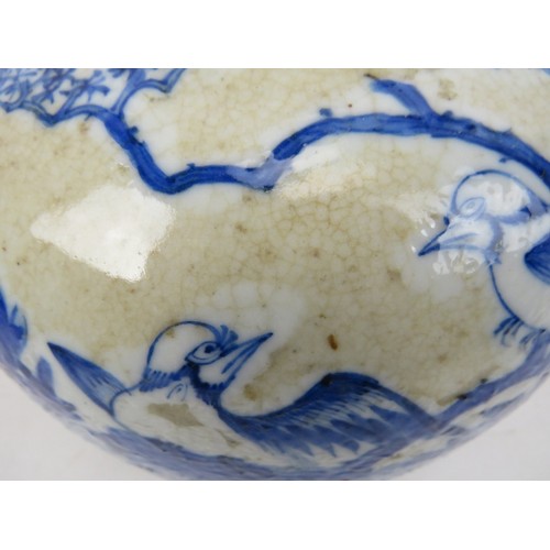 63 - A 19th century Chinese blue and white crackle ware porcelain vase and cover in the Kangxi style pain... 