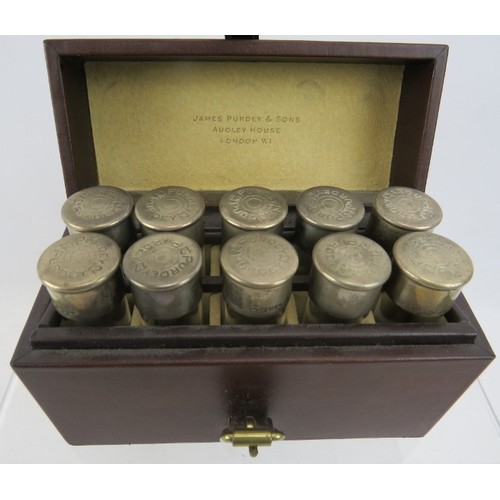 410 - A unusual travelling case of 10 individually numbered small glass bottles with silver tops marked Pu... 