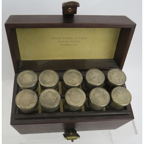 410 - A unusual travelling case of 10 individually numbered small glass bottles with silver tops marked Pu... 