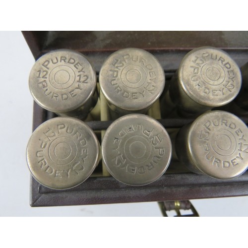 410 - A unusual travelling case of 10 individually numbered small glass bottles with silver tops marked Pu... 