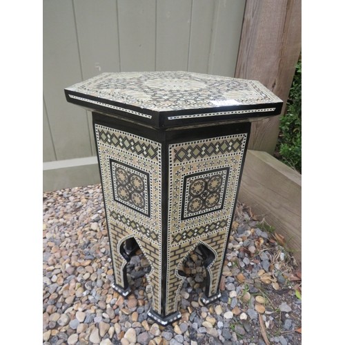 712 - A highly decorative Moorish octagonal occasional table, with mother of pearl and bone geometric inla... 