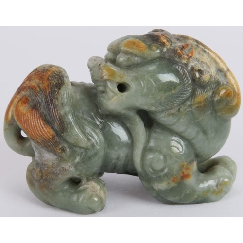 83 - A Chinese carved celadon and russet Jade Dog of Fo, Ming style but likely Qing, 7cm long x 5cm high.... 