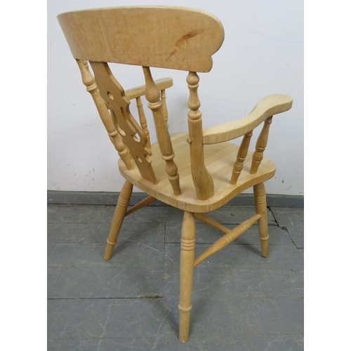 762 - A single beech carver farmhouse kitchen chair with shaped and pierced backsplat and turned spindles,... 