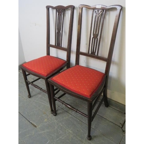 766 - A pair of Edwardian mahogany side chairs, strung with satinwood, the seats upholstered with scarlet ... 