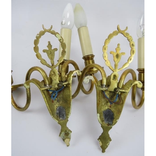 11 - A pair of Neo Classical revival cast gilt-metal twin-branch wall lights. 9.1 in (23 cm) height. 
Con... 