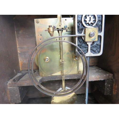 112 - Junghans mantle clock. Architectural oak case, coil strike, with key included. Bevelled glazed doors... 