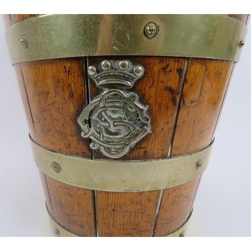 117 - A metal banded oak bucket, 19th century. Swing handled with two crowned monogramed appliques, 12.5