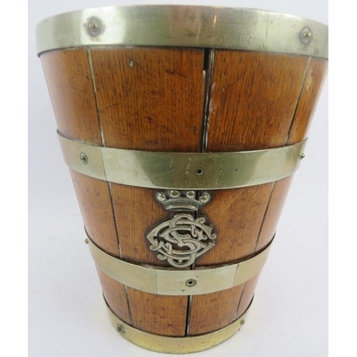 117 - A metal banded oak bucket, 19th century. Swing handled with two crowned monogramed appliques, 12.5