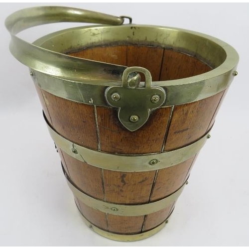 117 - A metal banded oak bucket, 19th century. Swing handled with two crowned monogramed appliques, 12.5