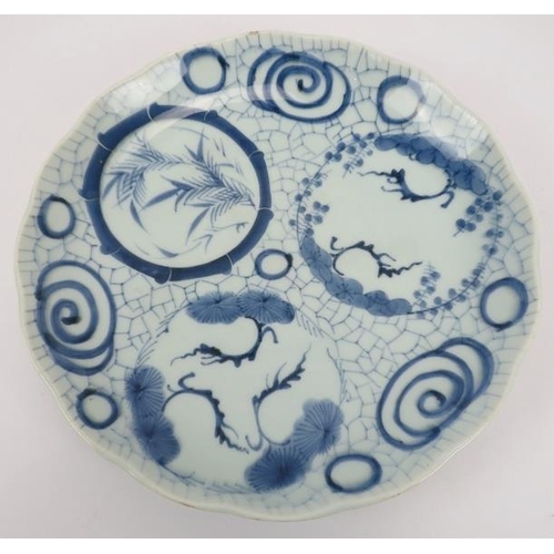 21 - A group of Japanese ceramics. Comprising a blue and white dish, 32cm diameter, an Imari fluted dish,... 