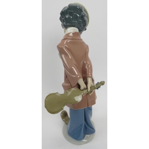 25 - A Lladro porcelain figure 'Clown with Violin'. Model No 5057. 10.6 in (32 cm) height. Original box i... 