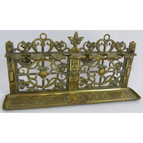 56 - An ornate Edwardian mahogany pipe rack, a cast brass aesthetic movement pipe rack and two tobacco pi... 