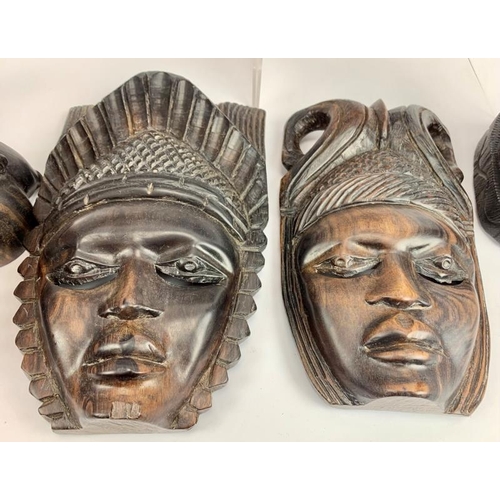 57 - Collection of African carved figures and heads. Assorted hard woods and zebra skin drum, 16cm height... 