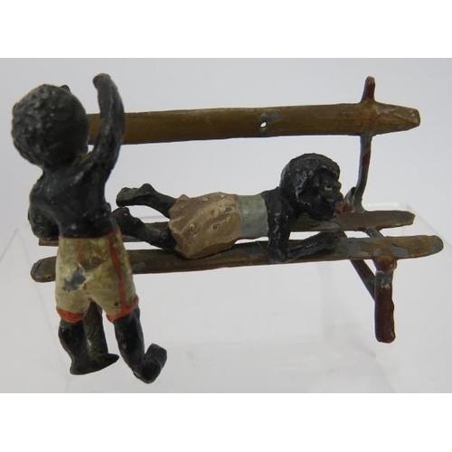 67 - Two small cold painted metal sculptures in the manner of Bergman. Depicting children at play 6cm and... 