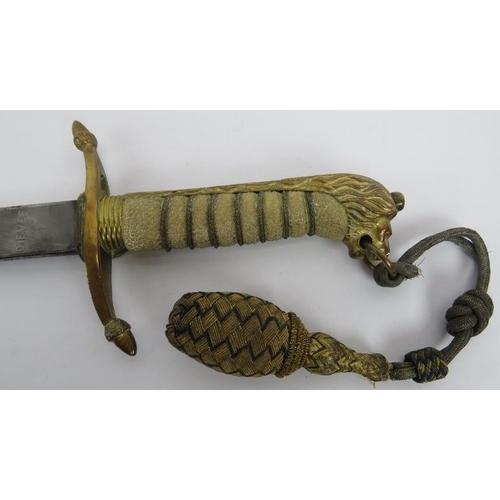 7 - A George VI Royal Navy Midshipman's dirk and scabbard. Engraved blade with shagreen handle, lions he... 