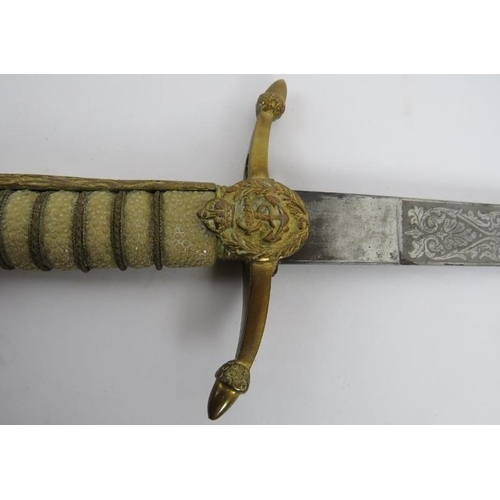 7 - A George VI Royal Navy Midshipman's dirk and scabbard. Engraved blade with shagreen handle, lions he... 