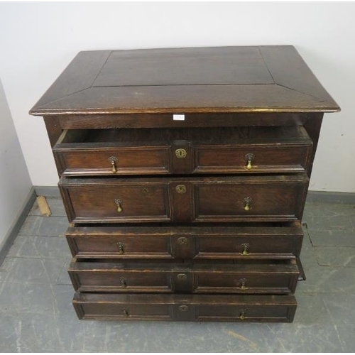 701 - A 17th century and later oak chest housing five graduated drawers with geometric moulding and brass ... 