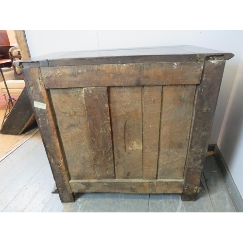 701 - A 17th century and later oak chest housing five graduated drawers with geometric moulding and brass ... 