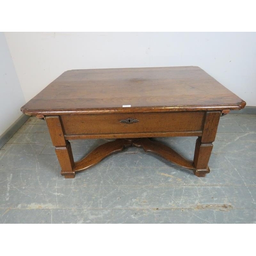 706 - An 18th century and later French oak coffee table with rounded corners, the top sliding to reveal a ... 