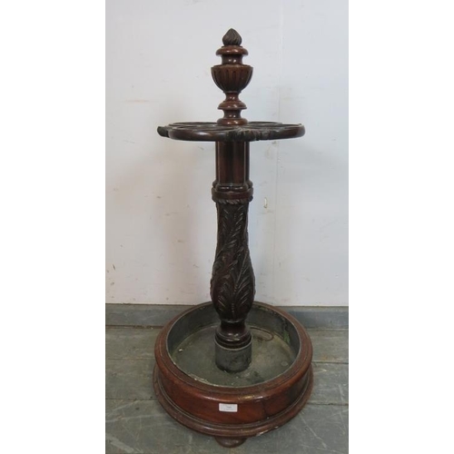 708 - A good quality Victorian mahogany stick stand, the centre finial carved with a Chimera, above four c... 