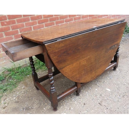 715 - A late 17th/early 18th century oak oval gate-leg table of good colour, with single drawer, on barley... 