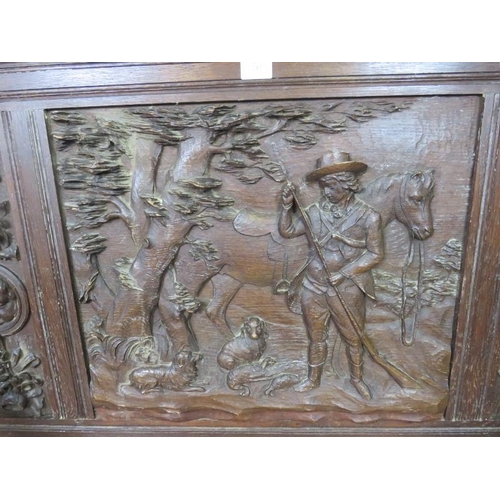 717 - A 19th century high back oak settle, ornately carved in the 17th century taste with figural scene de... 