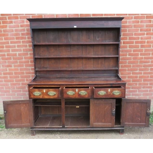 718 - An 18th century oak Welsh dresser with three open shelves over a dresser base housing three short dr... 