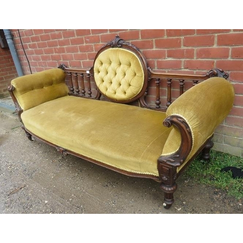 719 - A Victorian walnut show-wood sofa, with carved cornice, reeded spindles and acanthus carved and scro... 