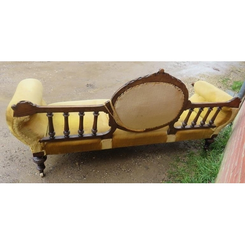 719 - A Victorian walnut show-wood sofa, with carved cornice, reeded spindles and acanthus carved and scro... 