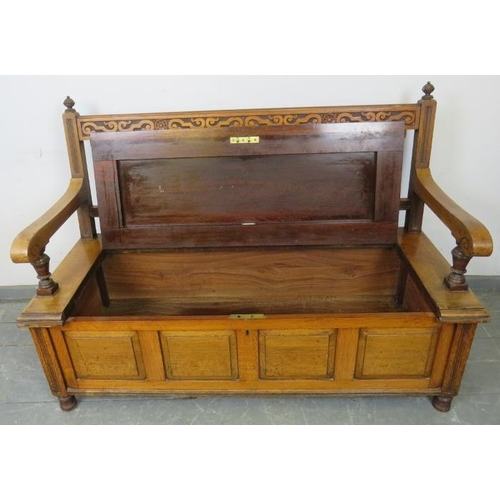 720 - An Arts & Crafts walnut settle by James Shoolbred, with turned ball finials, carved frieze and turne... 