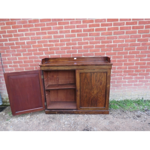 721 - A 19th century rosewood low enclosed bookcase with ¾ gallery, the panelled doors opening onto two he... 