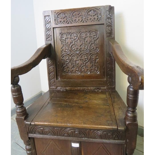 732 - A 17th century and later oak wainscot chair, with relief carved panel back, above a box base with st... 