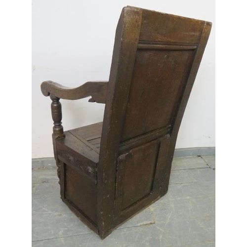 732 - A 17th century and later oak wainscot chair, with relief carved panel back, above a box base with st... 