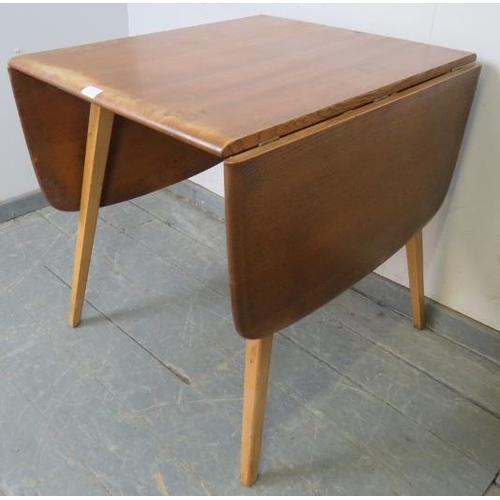 736 - A mid-century ‘Windsor’ elm and beech drop-leaf dining table, on canted supports. 
H71cm W61-136cm D... 