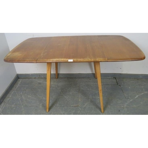 736 - A mid-century ‘Windsor’ elm and beech drop-leaf dining table, on canted supports. 
H71cm W61-136cm D... 