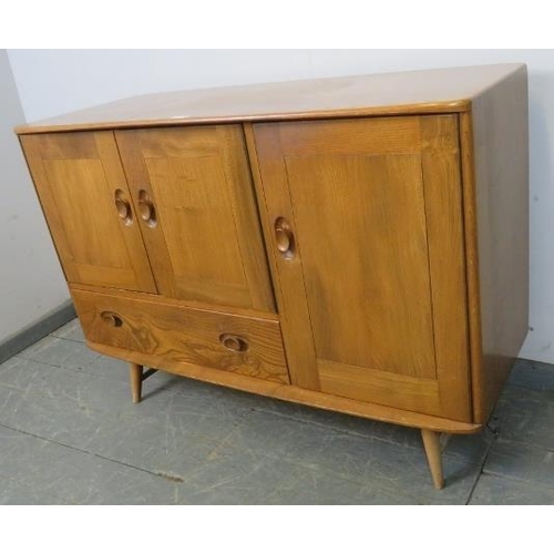 737 - A mid-century ‘Windsor’ elm and beech sideboard by Ercol housing two cupboards, (one with cutlery dr... 