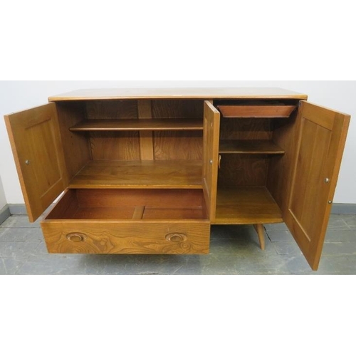 737 - A mid-century ‘Windsor’ elm and beech sideboard by Ercol housing two cupboards, (one with cutlery dr... 