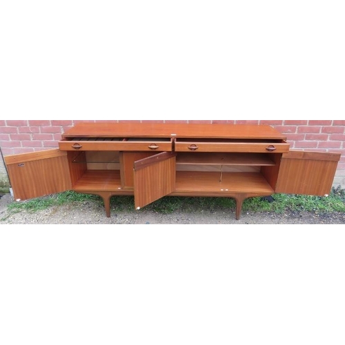 740 - A mid-century teak sideboard by Greaves & Thomas, housing two short drawers over cupboards with fitt... 