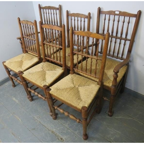 741 - A set of six (4+2) oak Lancashire spindle-back dining chairs with rush seats, on tapering supports w... 